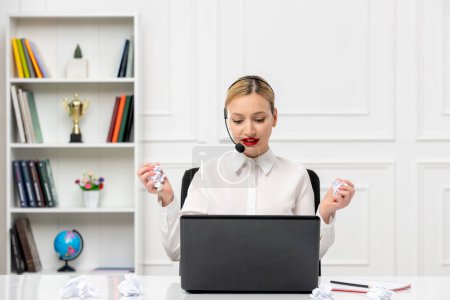 Photo for Customer service cute blonde girl office shirt with headset and computer holding a crumbled paper - Royalty Free Image