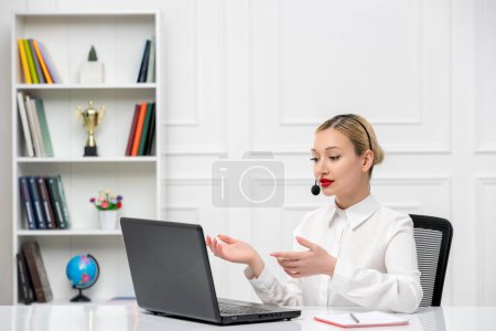 Photo for Customer service cute blonde girl office shirt with headset and computer looking at screen - Royalty Free Image
