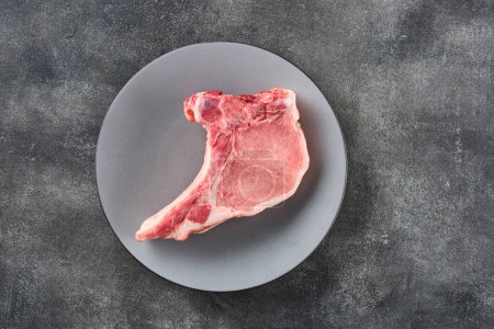 Photo for Fresh  Raw pork loin with bone over grey background. Pork chop. - Royalty Free Image