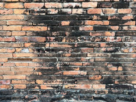 Photo for An aged, cracked and dirty brown brick wall. Brick wall background texture and wallpaper. Wall decoration and design. - Royalty Free Image
