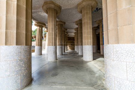 Photo for Front perspective of hall with columns with fragments of tiles and ceiling with small domes, Hypostyle room in Park Guell by Antoni Gaud, sightseeing day in Barcelona, Catalonia Spain - Royalty Free Image