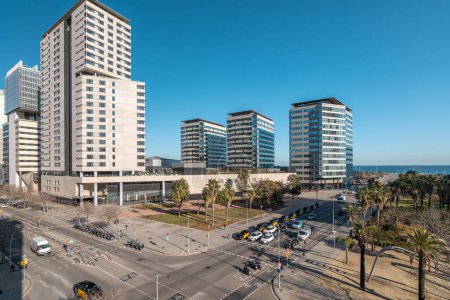 Photo for Modern buildings and car traffic intersection in the coastal residential area of Diagonal Mar in Barcelona, Spain. - Royalty Free Image