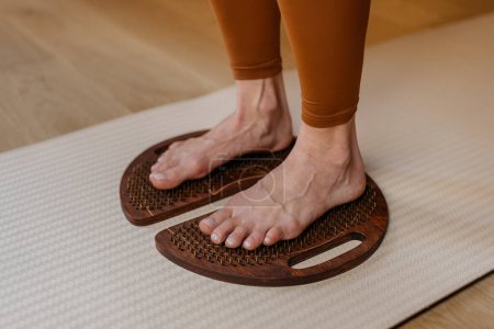 A moment of wellness captured with feet pressed against the pegs of acupressure boards.