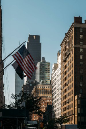 A single American flag stands out against the urban backdrop of NYC.