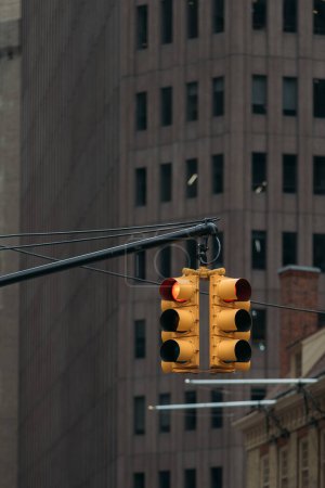 semáforo mostrando señal roja en el centro de Nueva York con un fondo de edificios altos y rascacielos.
