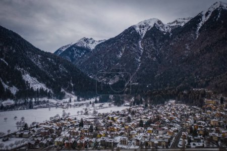 Aerial photography with drone. Great view of the Pinzolo Italy ski resort in winter time. January 2023