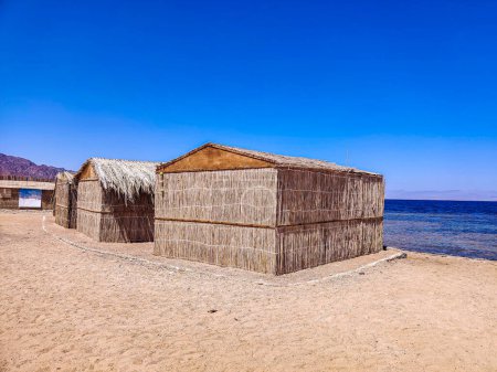 Photo for Cottage in a Bedouin Camp on the Sea in Ras Shitan in Oasis in Sinai, Taba desert with the Background of the Sea and Mountains. - Royalty Free Image