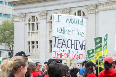 Photo for Oakland, CA - May 4, 2023: Teachers and supporters holding signs protesting at a Teacher Strike Rally at Frank Ogawa Plaza. - Royalty Free Image