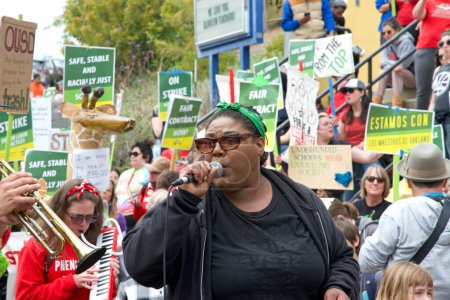 Photo for Oakland, CA - May 11, 2023: Music teacher Erica Richardson, leading chants at the Teacher Strike day 6 Rally outside Glenview Elementary School. - Royalty Free Image