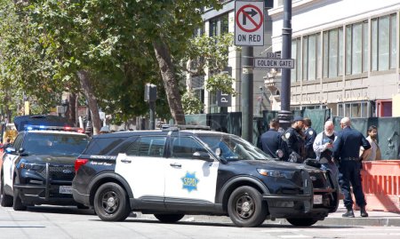 Photo for San Francisco, CA - Aug 12, 2023: Police arresting a protesteor during the 30th annual Pistahan Parade. Vehicles standing by with officers. - Royalty Free Image