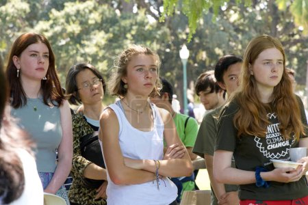 Photo for San Mateo, CA - Aug 5, 2023: Student youth leaders listen to politicians speaking at a Youth lead climate strike in San Mateo at Central Park. - Royalty Free Image