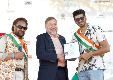 Photo for Fremont, CA - Aug 20, 2023: Tom Pyke, staffer for Congressman Ro Khanna presenting an award to singer Yash Wadali at the 31st annual FOG Festival. An annual celebration of Indian heritage and culture. - Royalty Free Image