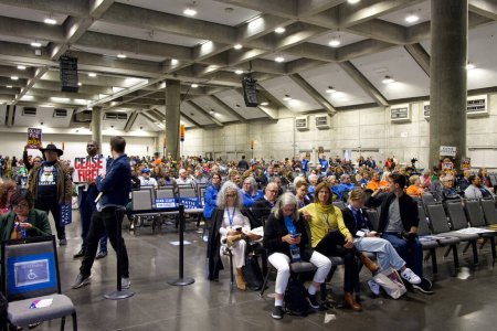 Photo for Sacramento, CA - Nov 18, 2023: Spectators in the auditorium for the CADEM Endorsing Convention General Session Senate Candidate Interviews. Some protestors holding signs. - Royalty Free Image