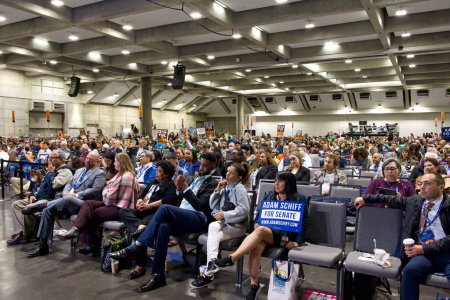 Photo for Sacramento, CA - Nov 18, 2023: Spectators in the auditorium for the CADEM Endorsing Convention General Session Senate Candidate Interviews. Some protestors holding signs. - Royalty Free Image