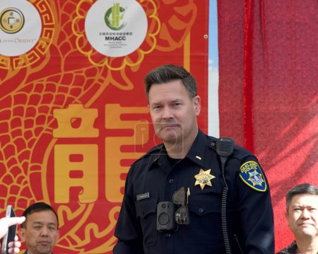 Photo for Oakland, CA - Feb 18, 2024: Police Commander Jeff Thomason preparing to speak at the opening ceremony for 2nd annual Lunar New Year Parade in Oakland. - Royalty Free Image