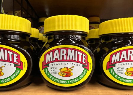 Photo for Oakland, CA - July 1, 2022: Grocery store shelf with jars of Marmite brand Yeast Extract. A by-product of beer brewing, enjoyed at any time on toast for breakfast, in sandwiches at lunchtime - Royalty Free Image