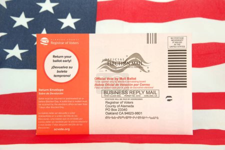 Photo for Alameda, CA - Nov 6, 2022: Midterm election ballots sent out to all registered voters in California. American flag in background. - Royalty Free Image