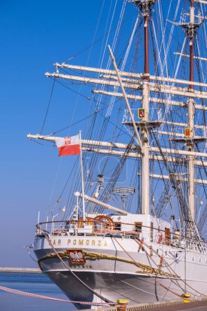 Téléchargez les photos : Gdynia Poland May 2022 Flag of Poland waving on flag pole of ship. Polish flag fluttering while sailing boat on sea. Sunny day - en image libre de droit
