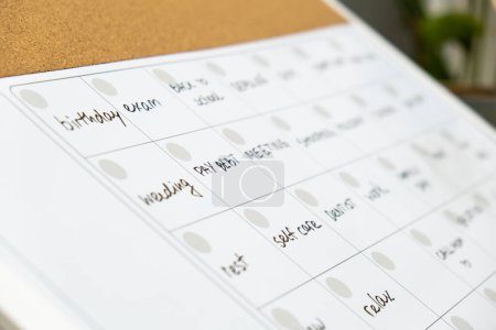 Photo for Monthly PLANNER filled with appointments and plans for next month. Busy month schedule. Magnetic board with the days of the month. Place to enter important matters schedule. Concept for business - Royalty Free Image