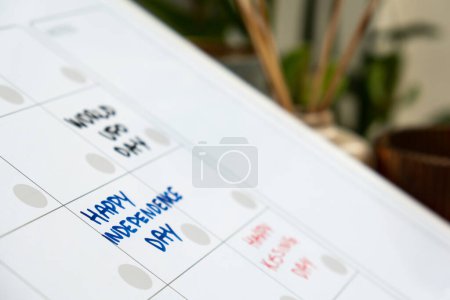 Photo for HAPPY INDEPENDENCE DAY on calendar to remind important event or holiday appointment Monthly PLANNER. Magnetic board with the days of the month. Place to enter important matters schedule. Concept for business planning. Whiteboard Planner magnetic mont - Royalty Free Image