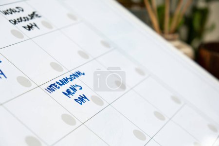 Photo for INTERNATIONAL MENS DAY on calendar to remind important event or holiday appointment Monthly PLANNER. Magnetic board with the days of the month. Place to enter important matters schedule. Concept for - Royalty Free Image