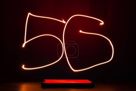 Foto de Abstract red lines long exposure light shape of 5G. Network internet mobile wireless business concept Innovations in the future 5G cellular and Internet speeds. - Imagen libre de derechos