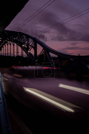 Photo for Defocused Lights of cars at night in Krakow bridge. Street line lights. Night highway city. Long exposure photograph night road. Colored bands of red light trails on the road. Background wallpaper - Royalty Free Image