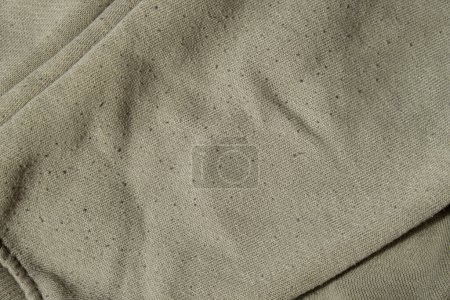 Photo for Lints on green sweater. Before cleaning and collected fluff lint. Closeup Pilled Clothes. Old used Clothes with lint pilling. Restoration of old damaged care. Repairing fabric textile reducing - Royalty Free Image