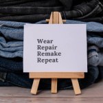 WEAR REPAIR REMAKE REPEAT text on paper note on Jeans clothes assortment Second hand sustainable shopping. Capsule minimal wardrobe. Sustainable fashion overconsumption, conscious buying consumption