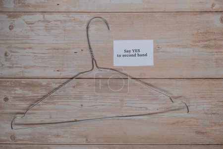 Photo for SAY YES TO SECOND HAND text with clothes rack. Second hand sustainable shopping. Capsule minimal wardrobe. Sustainable fashion overconsumption, conscious buying consumption, slow fashion idea concept - Royalty Free Image