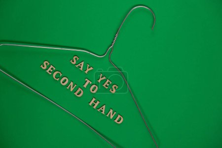 Photo for SAY YES TO SECOND HAND text with clothes rack. Second hand sustainable shopping. Capsule minimal wardrobe. Sustainable fashion overconsumption, conscious buying consumption, slow fashion idea concept - Royalty Free Image