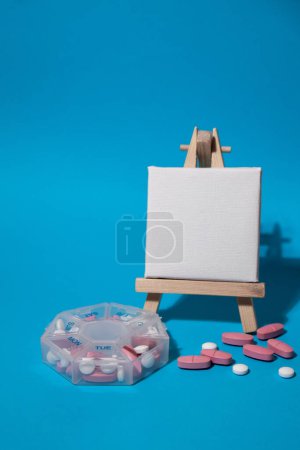 Photo for Closeup of medical pill box with doses of tablets for daily take medicine with white pink drugs and capsules with paper note Copy space for your text template mock up. Daily vitamins at home. Medication dietary supplements, immunity and disease preve - Royalty Free Image