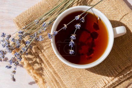 Lavender flowers with herbal cup of tea. Concept of Herbal medicine natural remedy. Organic relieving stress. Healthy beverage fresh delicious floral hot tea. Antispasmodic effect naturopathy concept