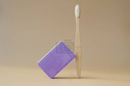 Bamboo toothbrush and Lavender soap on beige background with copy space for your text. Advertisement template mock up. Skincare homemade natural cosmetic concept. Organic dry lavender flower. Handmade