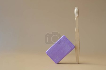 Eco friendly bamboo toothbrush and Handmade aromatic spa lavender soap. Natural additives and extracts. Bar of lavender soap with dried flowers. Beauty treatment product herbal ecological organic cosmetics. Copy space