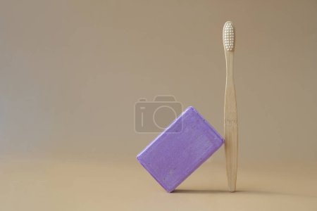 Eco friendly bamboo toothbrush and Handmade aromatic spa lavender soap. Natural additives and extracts. Bar of lavender soap with dried flowers. Beauty treatment product herbal ecological organic