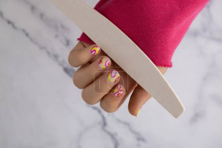 Woman manicured hands, stylish summer colorful nails. Closeup of manicured nails of female hand. Summer style of nail design concept. Beauty treatment.