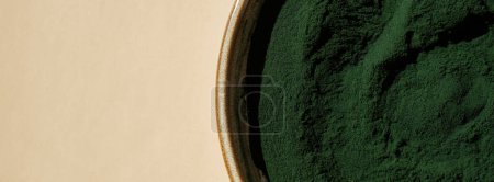 Organic blue-green algae spirulina powder food in plate. Copy space for your text Health benefits of spirulina chlorella. Vitamins and minerals to diet. Detox dietary supplement Seaweed superfood