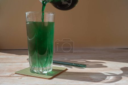 Organic blue-green algae spirulina detox drink in glass powder food. Health protein cocktail smoothie of chlorella. Vitamins and minerals to diet. Prebiotic and antioxidant rich Dietary supplement