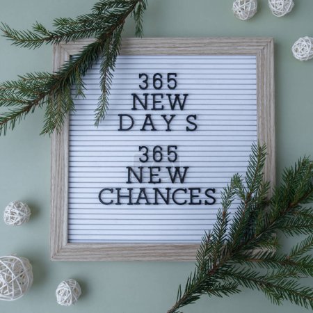 Photo for 365 NEW DAYS 365 NEW CHANCES text on white letter board on green background with Christmas decor. New year aims resolutions. New year me concept - Royalty Free Image