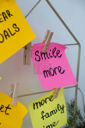 Photo for SMILE MORE self care goal on Action board new years resolutions on colorful sticky notes. Making promises for new year, setting goals. Dream year motivation - Royalty Free Image