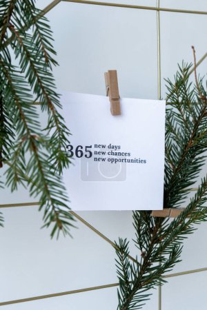 Photo for 365 NEW DAYS CHANCES OPPORTUNITIES text on white paper note on vision board with Christmas decor. New year aims resolutions. New year New me concept - Royalty Free Image