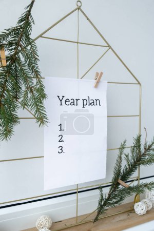 Photo for Vision board with YEAR PLAN new year resolutions aims goals on paper note. Preparation for New Year. Concept of planning and setting goals for personal development - Royalty Free Image