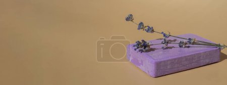 Lavender soap on beige background with copy space for your text. Advertisement template mock up. Skincare homemade natural cosmetic concept. Organic dry lavender flower. Handmade soap 