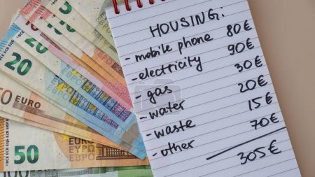 Counting expenses bills on housing electricity, gas, water. Banknotes of euro cash around. High prices for energy inflation crisis. Cut back on spending. Savings rate