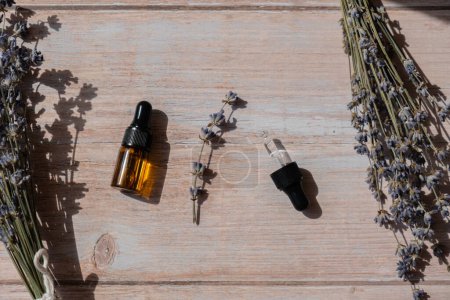 Dried lavender flowers with glass dropper of natural essential oil. Organic herbal aromatherapy healthy glass bottle. Home fragrance extract. Beauty care