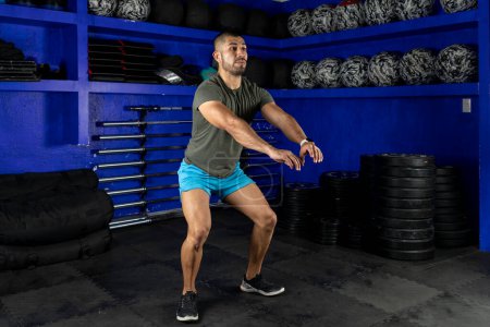 Photo for Man in sportswear doing squats in a crossfit gym - Royalty Free Image
