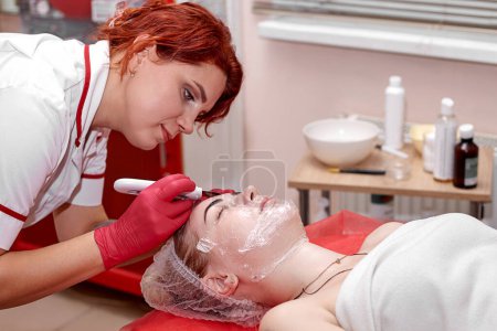 Woman cosmetologist doing ultrasonic peeling