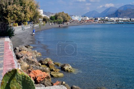 Foto de Ierapatra, Creta, Grecia - 12 de octubre de 2022: Personas no identificadas en la playa de la ciudad más meridional de Europa en el Mar de Libia - Imagen libre de derechos