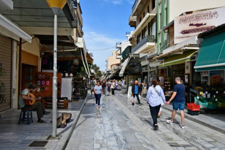 Photo for Iraklio, Greece - October 14, 2022: The capital of Crete Island, unidentified people and shops, street musician playing traditional bouzouki - Royalty Free Image